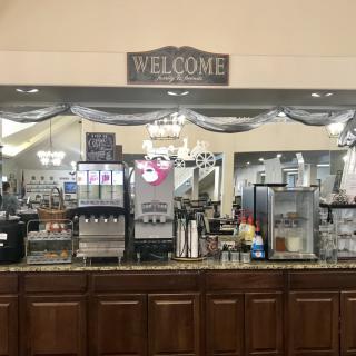 A welcoming view of a coffee shop counter with beverage machines and decor.