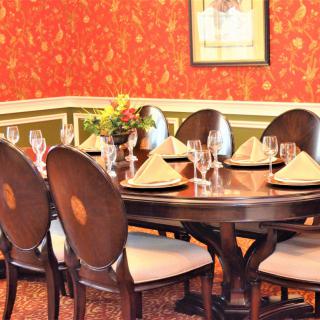 A beautifully set dining table with elegant decor and a flower arrangement.