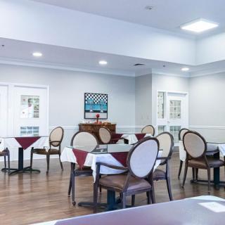 An empty dining room with neatly arranged tables and chairs.