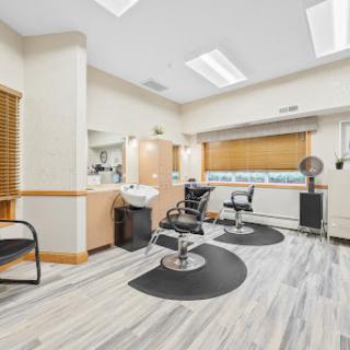 A modern hair salon featuring stylish barber chairs and a bright interior.