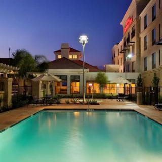 A serene hotel pool illuminated at dusk, perfect for unwinding after a long day.