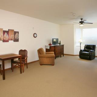 A minimalist living room with comfortable seating and a TV.