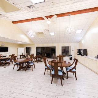 A spacious and well-lit dining area with multiple tables and chairs.