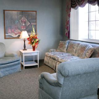 A cozy living room featuring comfortable seating and decorative elements.