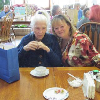 Two women enjoying a cup of tea at a cafe.