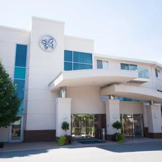 Modern building entrance with a sleek design and large windows.
