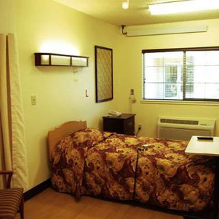 A modestly furnished room with a single bed and window.
