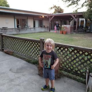 A cheerful child enjoying an evening outdoors.