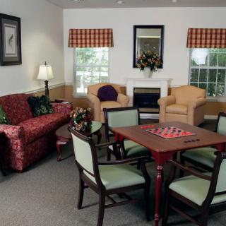 A cozy living room with a seating area and dining table.