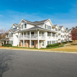 A suburban residential building with multiple apartments, showcasing modern architecture.
