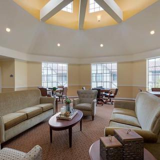 A spacious living room with comfortable seating, large windows, and a stylish coffee table.