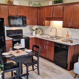 Cozy kitchen with modern appliances and a small dining area.