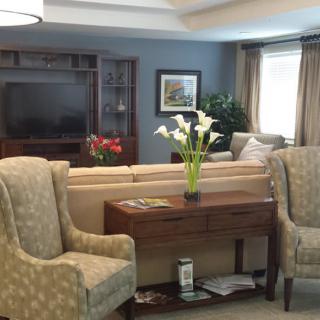 A cozy living room with elegant furniture and fresh flowers.
