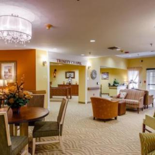 A cozy living room with comfortable seating and elegant lighting.