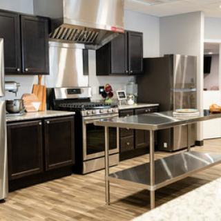 A modern kitchen with stainless steel appliances and a central island.