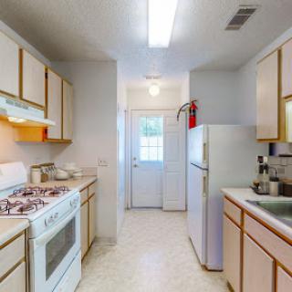 A bright and functional kitchen equipped with essential appliances.
