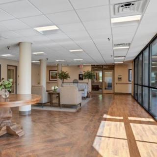 A modern office lobby with comfortable seating and large windows.