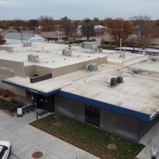 An aerial view of a commercial building with a flat roof and HVAC units.