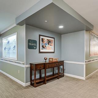 A well-decorated hallway with a wooden console table and framed artwork.