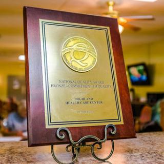 An award plaque displayed on a stand, symbolizing recognition and achievement.