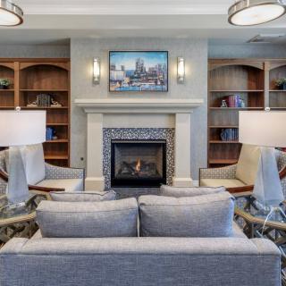 A modern living room featuring a cozy fireplace and stylish furniture.