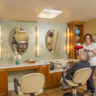 A hair stylist working in a cozy hair salon with modern decor.