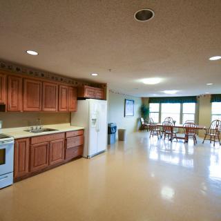 A spacious kitchen and dining area with wooden cabinets and modern appliances.
