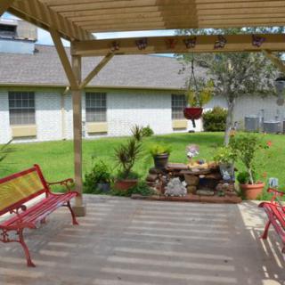 A cozy outdoor patio area with seating and beautifully arranged plants, perfect for relaxation.