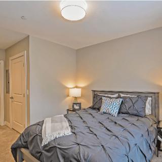 A modern and cozy bedroom with a neatly made bed and soft lighting.