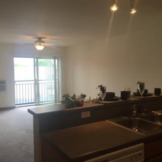 Open-plan kitchen and living room with a balcony view.