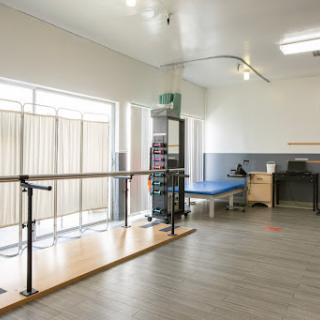 A spacious and well-equipped rehabilitation therapy room designed for patient exercises and recovery.