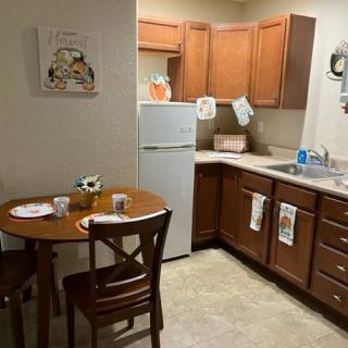 A cozy kitchen with wooden cabinets and a small dining area.