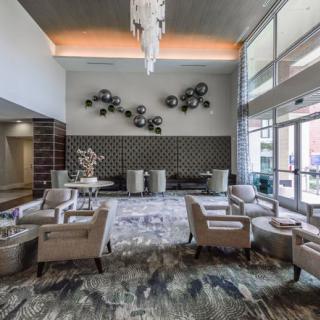 A modern hotel lobby with elegant seating and decorative wall art.