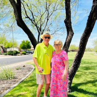A cheerful couple enjoying a sunny day in the park.