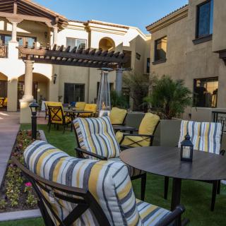 A well-furnished outdoor patio area with tables and chairs in a stylish courtyard.
