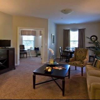 A cozy living room with elegant furniture and a connected dining area.