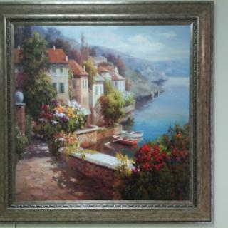 A tranquil waterfront scene showcasing charming houses surrounded by colorful flowers, set against a picturesque backdrop.
