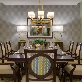 Elegant dining room with a stylish chandelier and classic furniture.