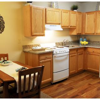 Cozy kitchen with wooden cabinets and a small dining area.