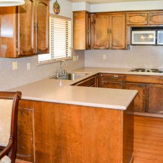 A cozy kitchen with wooden cabinets and modern appliances.