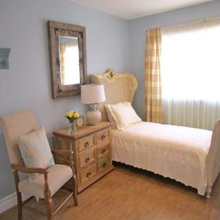 A cozy bedroom with a single bed and traditional furnishings.