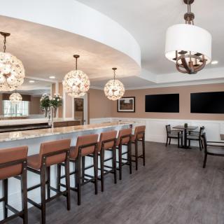 A modern bar interior with high seating and elegant lighting.