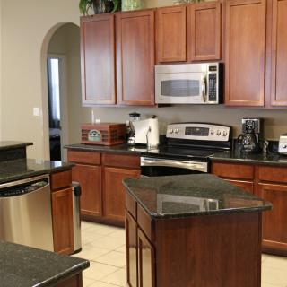 A modern kitchen with wooden cabinets and stainless steel appliances.
