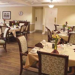 An elegantly set dining room with neatly arranged tables and chairs, ready for guests.