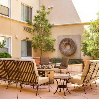 A cozy outdoor patio with comfortable seating and decorative elements.