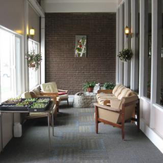 A cozy indoor lounge area with comfortable seating and plants.