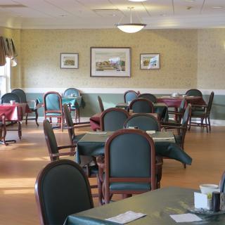 An empty dining room with neatly arranged tables and chairs.