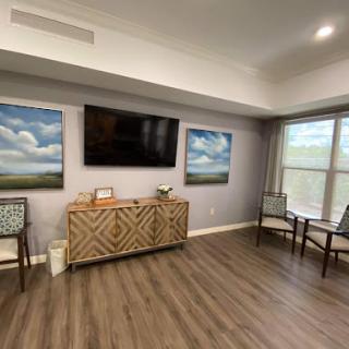 A cozy living room featuring modern decor, wall art, and a television.
