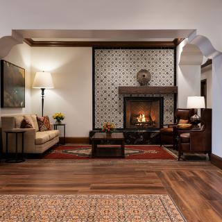 Cozy living room with a warm fireplace and elegant decor.