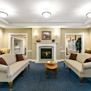A cozy living room with a fireplace, sofas, and a coffee table.